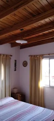 a bedroom with a bed and a window at Departamento Con Vistas a La Montaña in Villa Carlos Paz