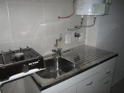 a kitchen with a sink and a stove at Departamento Con Vistas a La Montaña in Villa Carlos Paz