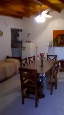 a room with a table with two chairs and a bed at Departamento Con Vistas a La Montaña in Villa Carlos Paz