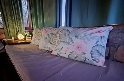 a bed with two pillows on top of it at Cabañas Pampa in Mina Clavero