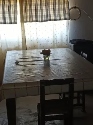 a table with a bowl on top of it at Posta Los Reartes in Los Reartes