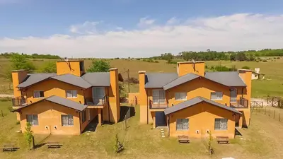 an aerial view of a row of houses in a field at Posta Los Reartes in Los Reartes