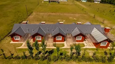 an aerial view of a house with solar panels on it at Posta Suites Apart - Los Reartes in Los Reartes
