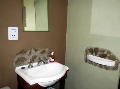 a bathroom with a sink and a mirror at Verde Niña Casas Serranas in Cortaderas