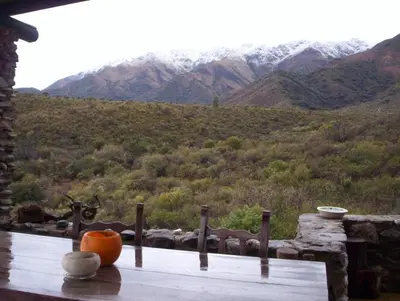 a pumpkin sitting on a table with a view of a mountain at Verde Niña Casas Serranas in Cortaderas