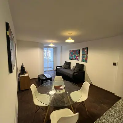 a living room with a couch and a table and chairs at Edificio Torre Agora in Cordoba
