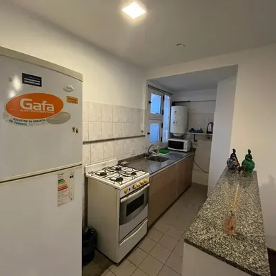 a kitchen with a stove and a refrigerator at Edificio Torre Agora in Cordoba