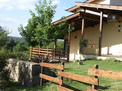 a wooden fence in front of a house at Terrazas de Piedra in Santa Rosa de Calamuchita