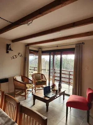 a living room with a couch and a table at Terrazas de Piedra in Santa Rosa de Calamuchita