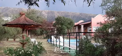 a resort with a swimming pool and a building at Punto Serrano in Carpintería