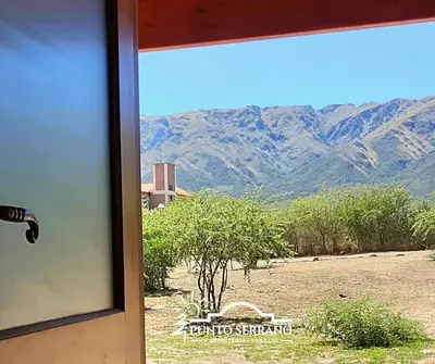 a view from a door of a window with a view of mountains at Punto Serrano in Carpintería