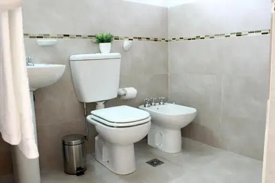 a bathroom with a toilet and a sink at Lomas del Vergel in Los Reartes