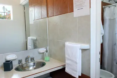 a bathroom with a sink and a mirror at Lomas del Vergel in Los Reartes