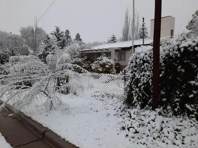 a fence covered in snow in front of a house at Lomas del Vergel in Los Reartes
