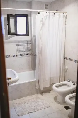 a bathroom with a tub and a toilet and a sink at 4 PERSONAS A 150 Mts SANATORIO ALLENDE in Cordoba