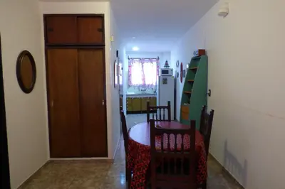 a kitchen with a table and chairs and a refrigerator at Departamento Centrico in Villa Carlos Paz