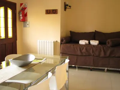 a living room with a couch and a glass table at Don Gregorio Spa in Merlo