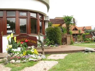 a house with a garden with flowers in front of it at Don Gregorio Spa in Merlo