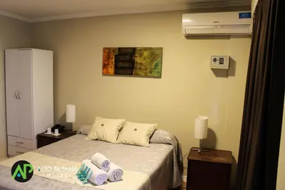a bedroom with a bed with towels on it at Hotel Alto Parana in Cordoba