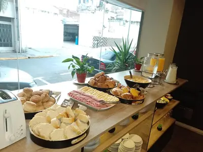 a table topped with lots of different types of bread at Hotel Alto Parana in Cordoba