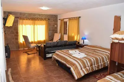 a bedroom with a bed and a couch at Hostal 