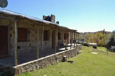 an old stone building with a stone wall at Hostal 
