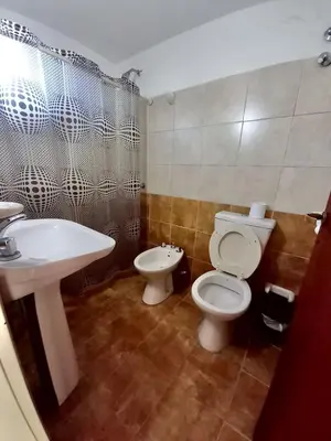 a bathroom with a toilet and a sink at Posada Vieja Estancia in Santa Rosa de Calamuchita