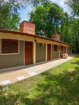a house with a porch and a patio at Posada Vieja Estancia in Santa Rosa de Calamuchita
