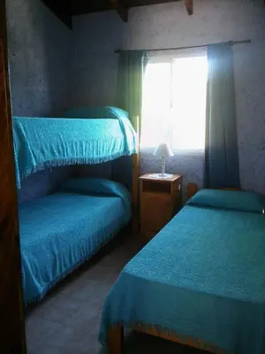a bedroom with two beds and a window at Apart Don Cosme in Santa Rosa de Calamuchita