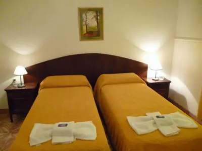 a hotel room with two beds with towels on them at Belvedere Hotel para Adultos in Santa Rosa de Calamuchita