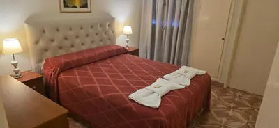 a hotel room with a bed with towels on it at Belvedere Hotel para Adultos in Santa Rosa de Calamuchita