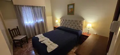 a hotel room with a bed with two bow ties on it at Belvedere Hotel para Adultos in Santa Rosa de Calamuchita
