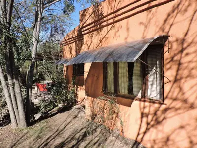 a building with a window on the side of it at Cabañas La Comarca in Merlo