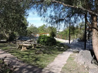 a park with a picnic table in the grass at Cabañas La Comarca in Merlo