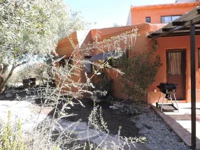 a side view of a house with a grill outside at Cabañas La Comarca in Merlo