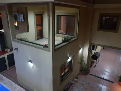 a living room with two windows and a fireplace at LOS ANDES Departamentos in Villa Carlos Paz
