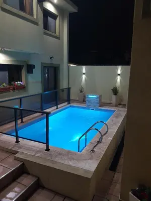 a large swimming pool in a building at night at LOS ANDES Departamentos in Villa Carlos Paz