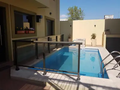 a swimming pool on the balcony of a house at LOS ANDES Departamentos in Villa Carlos Paz
