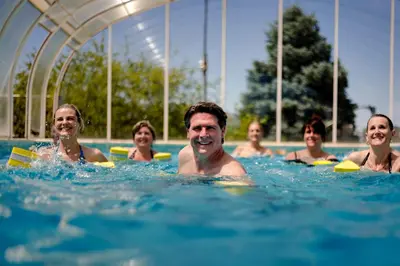 a group of people in a swimming pool at La Posada Del Qenti in Villa Carlos Paz