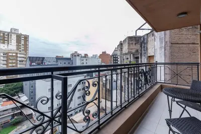 a balcony with a view of a city at Departamento luminoso con balcón, aire y Wi-FI-Nueva Córdoba in Cordoba