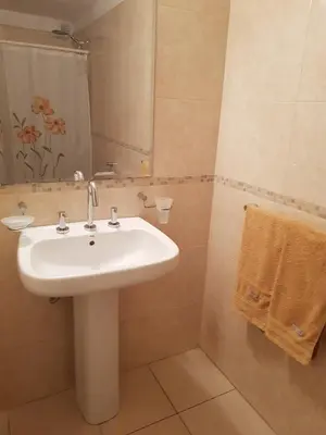 a bathroom with a white sink and a mirror at Juventus in Cordoba
