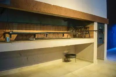 a shelf in a room with a chair in it at El Zuriaco in Santa Rosa de Calamuchita