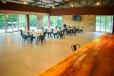 a large room with tables and chairs and windows at El Zuriaco in Santa Rosa de Calamuchita