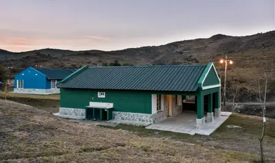 a house with a green roof on a hill at El Zuriaco in Santa Rosa de Calamuchita