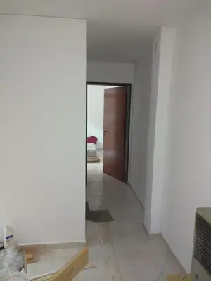 an empty room with a hallway with a door at Balcarce Suits PB in Bell Ville