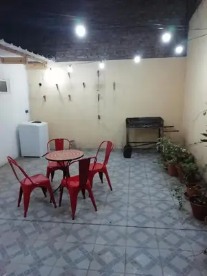 a room with a table and chairs and a piano at Balcarce Suits PB in Bell Ville