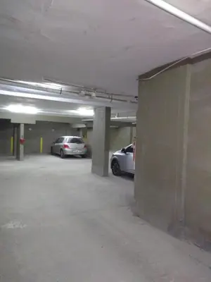 two cars parked in an empty parking garage at Balcarce Suits PB in Bell Ville