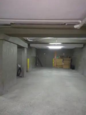 an empty parking garage with a car parked in it at Balcarce Suits PB in Bell Ville