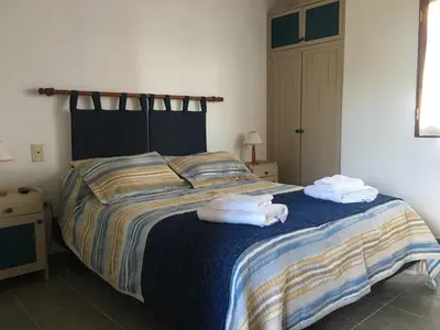a bedroom with a bed with towels on it at Residencial del Golf in Alta Gracia