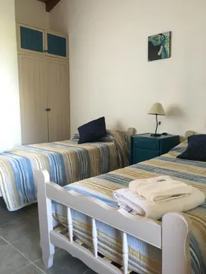 two beds sitting next to each other in a room at Residencial del Golf in Alta Gracia